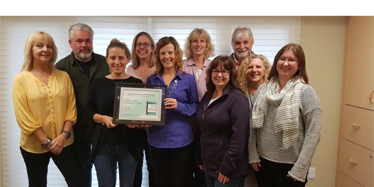 10 people standing and smiling with their their strategic planning certificate