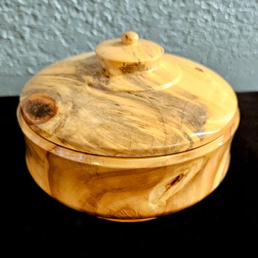Close-up of a wooden jar lid with natural grain.