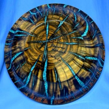 Wooden plate with blue resin inlays.