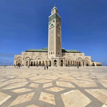 The Hassan II Mosque in Casablanca under a clear blue sky.