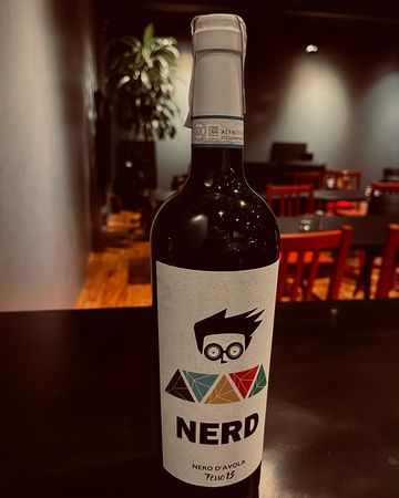 A bottle of wine labeled 'NERD' with a cartoon character on the label.