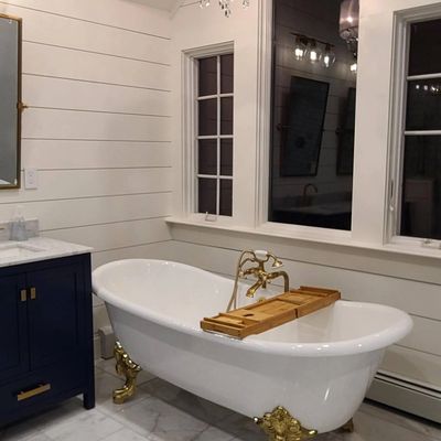 Navy clawfoot tub in bathroom