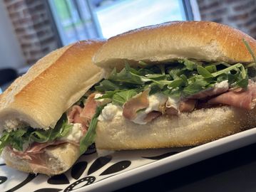 Fresh sandwich with greens and ham on a crusty baguette.