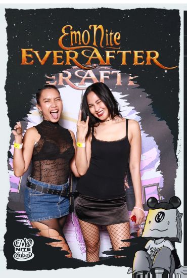 Two women posing happily at Emo Nite Dubai event.