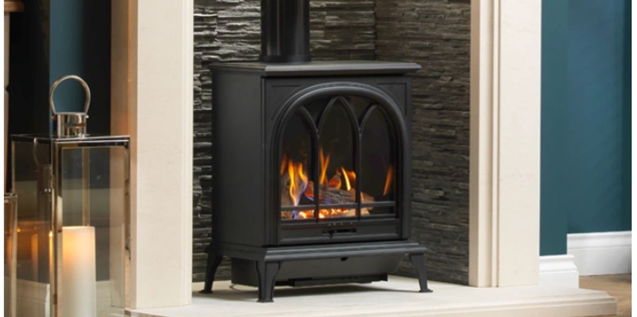 Gas Stoves in a marble Fireplace with granite fireplace in background 