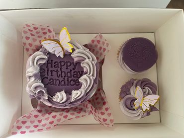 Purple coloured be to cake with cupcakes