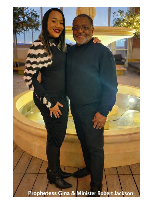 Prophetess Gina and Minister Robert Jackson pose happily by a fountain at night.