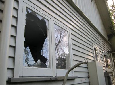 A broken glass window and compromised structure.