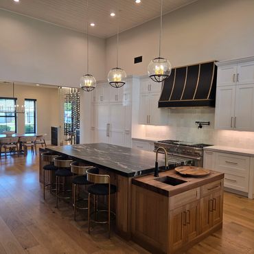 Modern kitchen with a large island and elegant lighting.