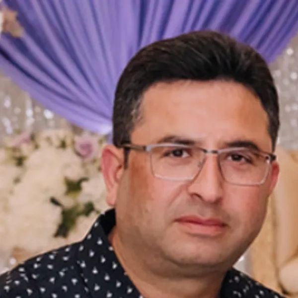 Man wearing glasses with a serious expression.