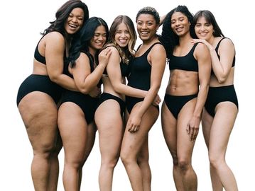Diverse group of women confidently celebrating smooth skin & body positivity.