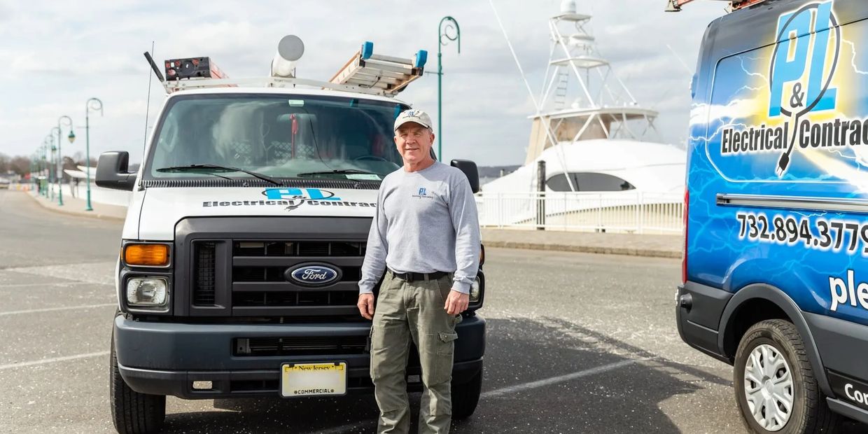 a man wearing a hat standing near a van 