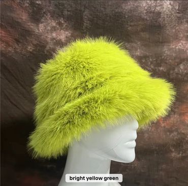 Bright yellow-green fluffy fur hat on a mannequin head.