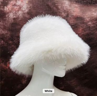 Fluffy white bucket hat with soft fur texture.