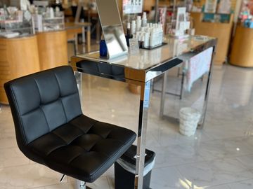 Black salon chair next to a mirror station.