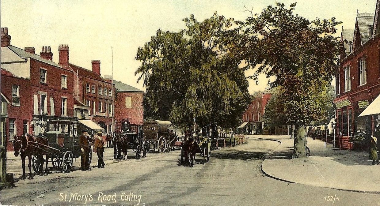 Vintage street scene on St. Mary's Road, Ealing, with horse-drawn carriages and brick buildings.