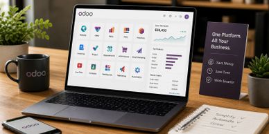 Laptop displaying Odoo business management software on a wooden desk.