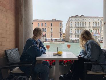 Two friends are sitting on the banks of river view 
