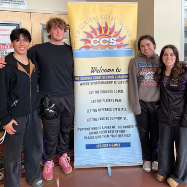 Four young athletes pose beside a Central Coast Section banner at a sports event.