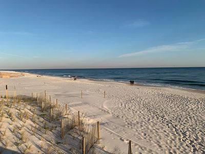 Photo of quiet sandy beach with a few people strolling along near Indigo East in Perdido Beach