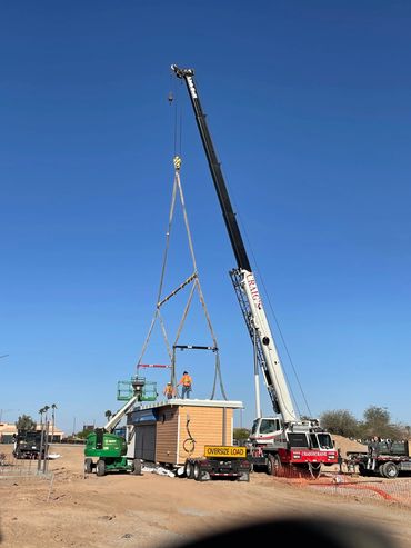 100 ton truck crane unloading container with three spreader bars.