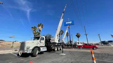 45 ton truck crane placing new IHOP sign.