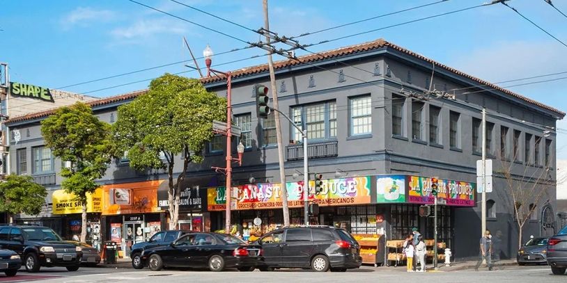 Two stories building with commercial spaces.