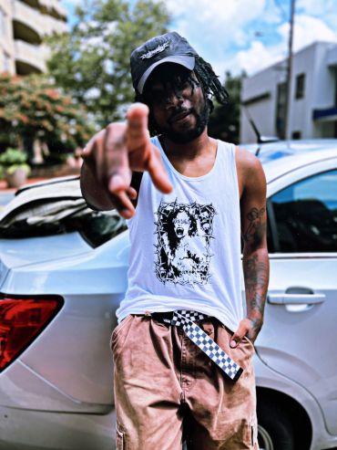 Man pointing at the camera in casual streetwear.