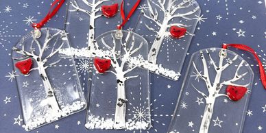 5 clear ornaments featuring white birch trees with a single cardinal sitting on a branch.