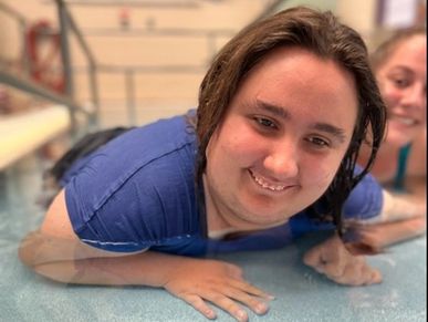 Adult female with developmental disabilities enjoying swimming