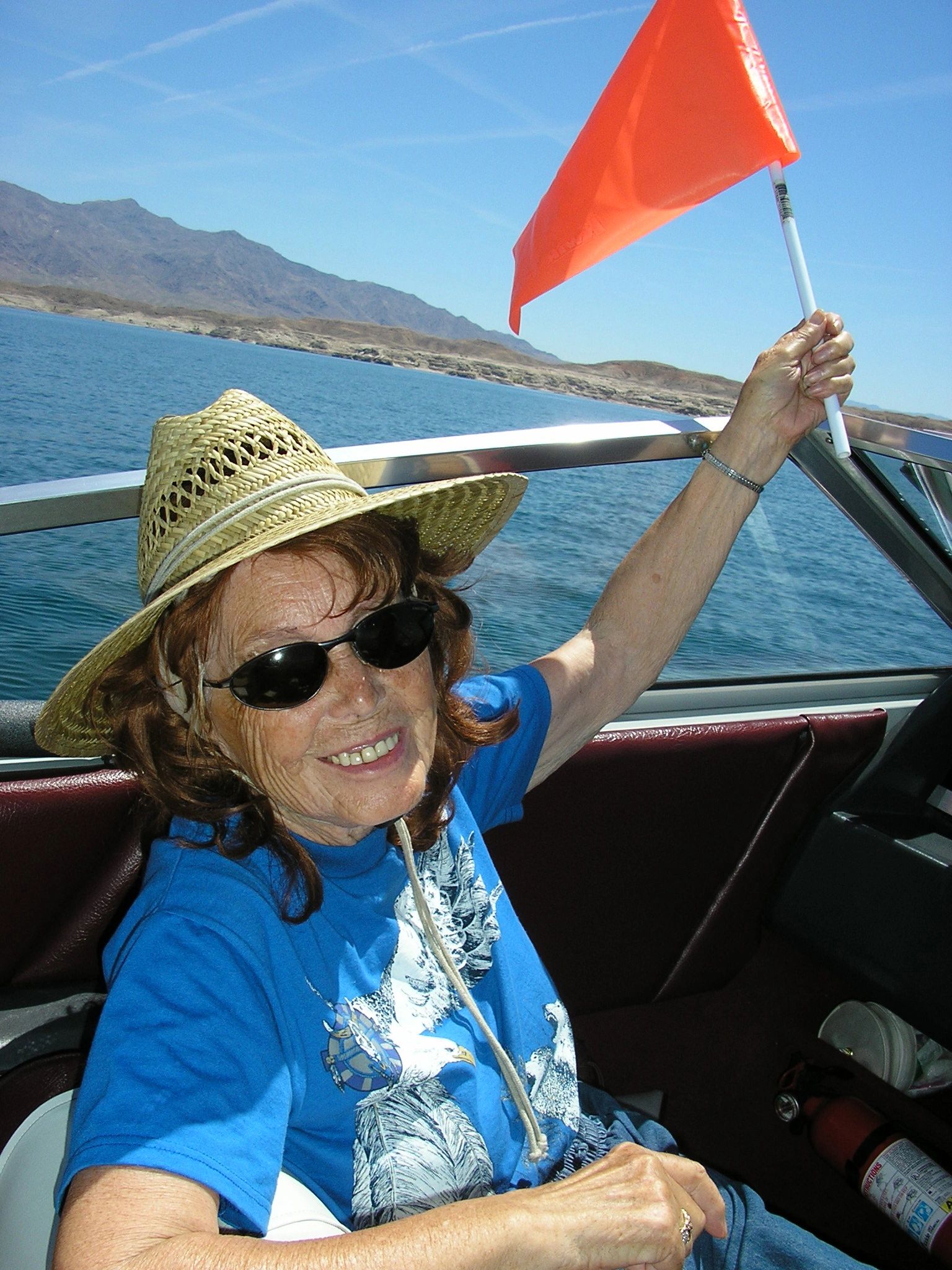 Grandma Rose holding the flag on the boat at 94. Lake Mead