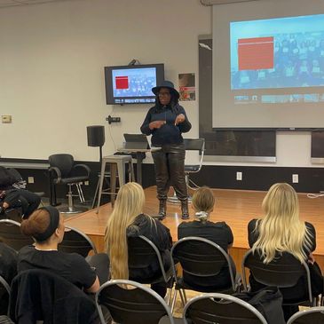 Person giving a presentation to an audience in a room.
