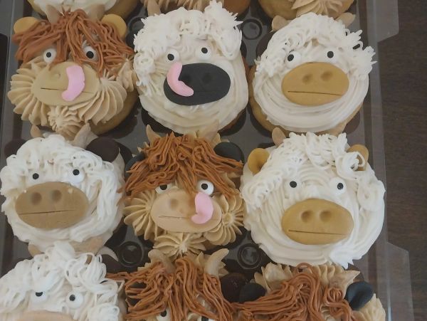 Animal-themed cupcakes with expressive faces and frosting details.
