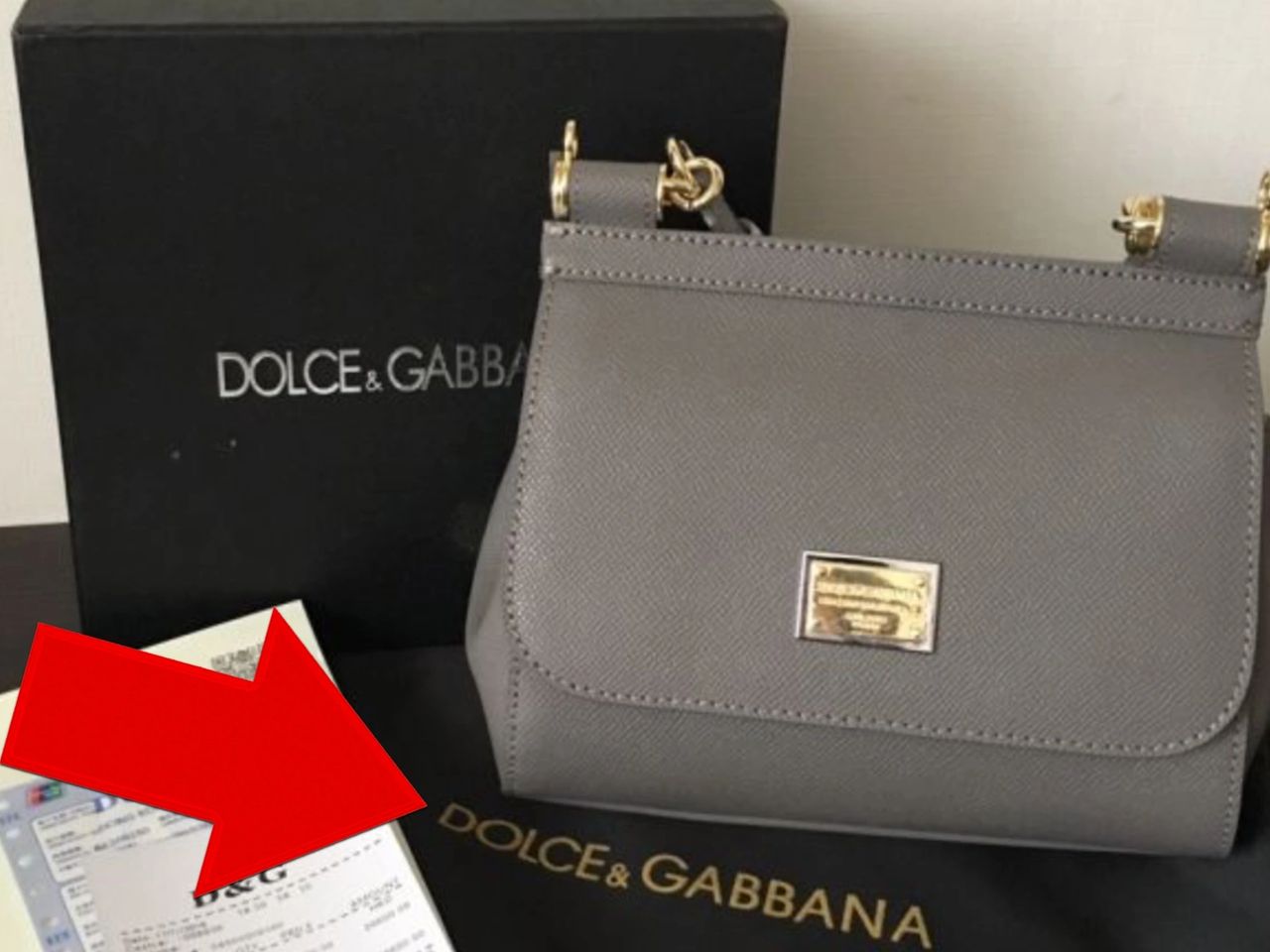 Dust bag of authentic purse has a white DOLCE & GABBANA logo, not gold or grey. The font should match the one you can find in bags sold on <a class=