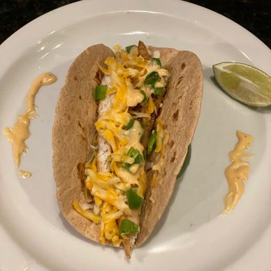 Beautifully plated redfish (red drum) tacos garnished with a lime wedge.