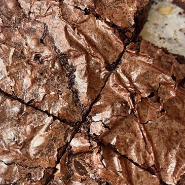 Close-up of freshly baked chocolate brownies with a cracked surface.