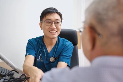 Doctor shaking hands with a senior patient.