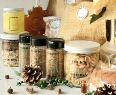 Variety of jars with spices and nuts on display.