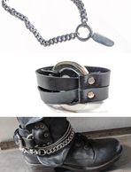 Black leather boot with metal chain and ring accessory.