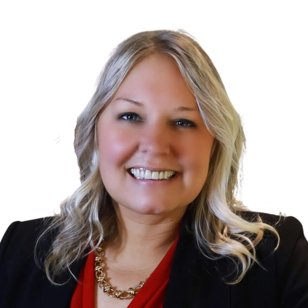 Smiling woman with blonde hair in professional attire.
