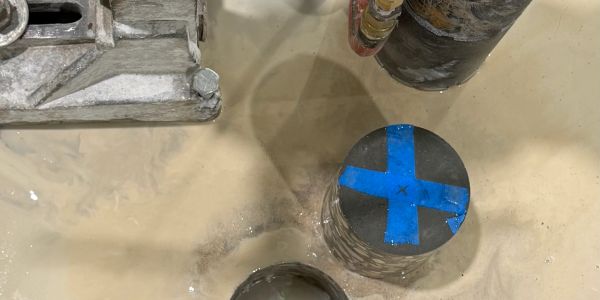 Concrete core drilling equipment creating a floor penetration in Houston