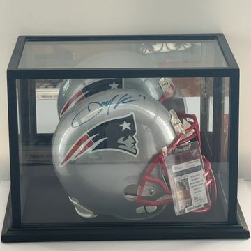 Signed New England Patriots helmet in display case.
