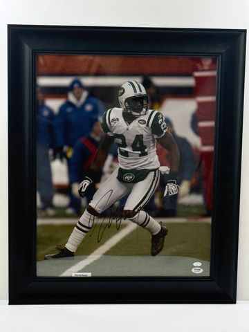 Framed autographed photo of a football player in Jets uniform.