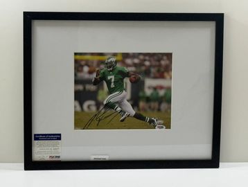 Framed autographed photo of a football player in green uniform.