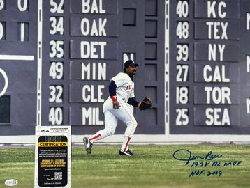 Baseball player near scoreboard with autograph.