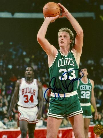 Larry Bird shooting a basketball during a game.