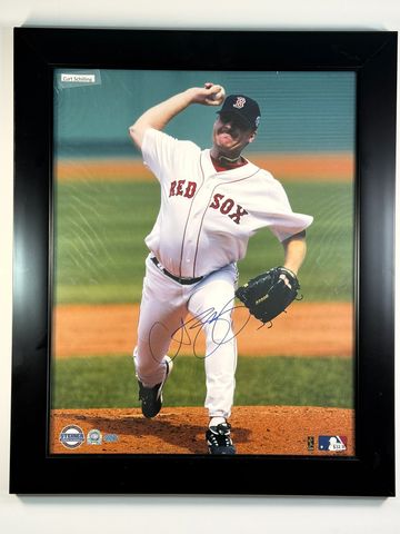 Autographed photo of Curt Schilling pitching for the Red Sox.