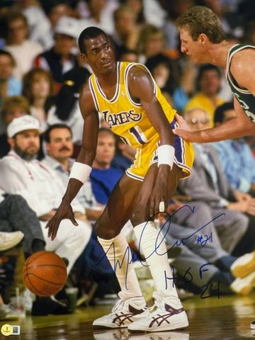 Lakers basketball player dribbling past a defender.