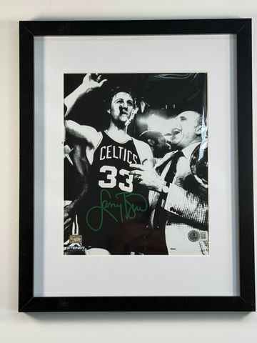 Black-and-white framed photo of Larry Bird with Celtics jersey.