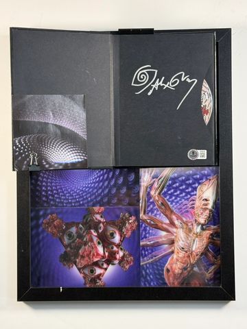 Opened black box with surreal artwork and a signed CD inside.